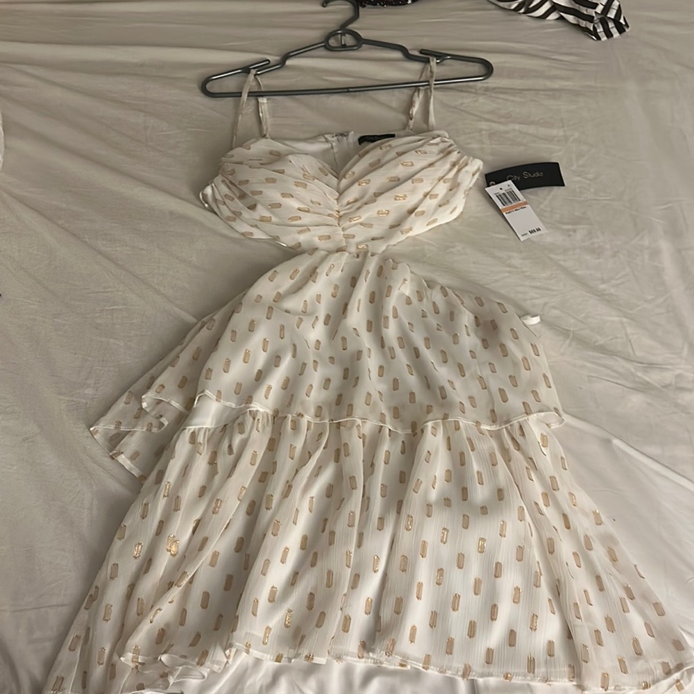 Cut out side/ back. Gold and just off white beautiful dress
